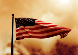 A waving flag with a smoky yellow sky background